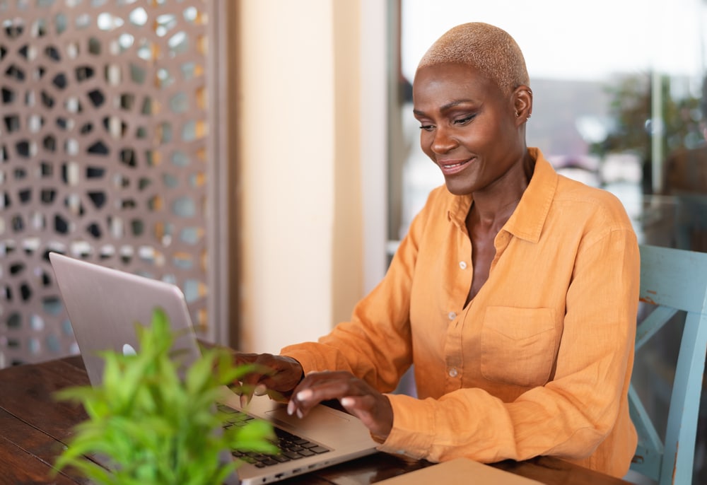 African,Woman,Working,On,Laptop,In,Bar,Restaurant,-,Afro 1764650046 e3dda606eee44df98b59852ffef5ea81 1